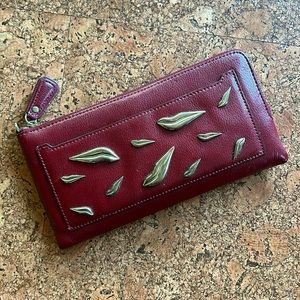Used red clutch. Missing wrist strap. 9” x 4.5”